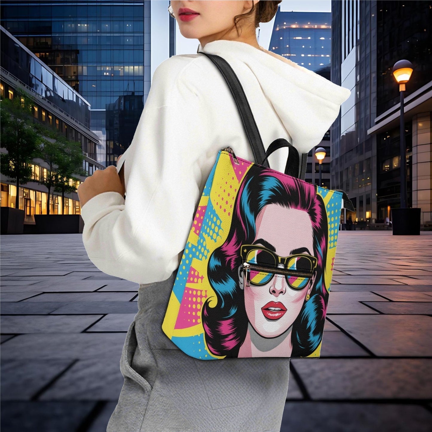 Person wearing a colorful backpack with a graphic design of a woman's face on a city street.